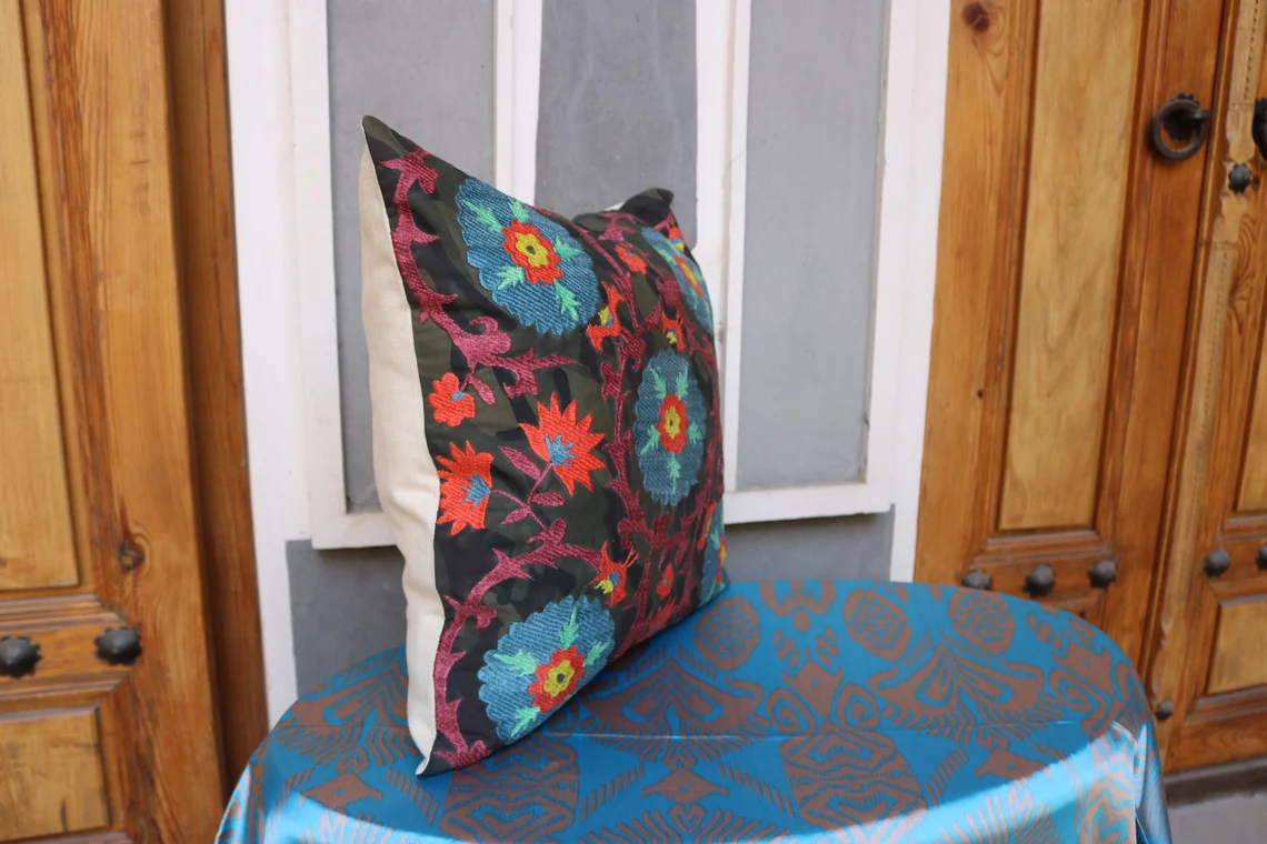Suzani pillowcase covers are traditional Uzbek textiles, hand-embroidered with vibrant floral and geometric patterns.