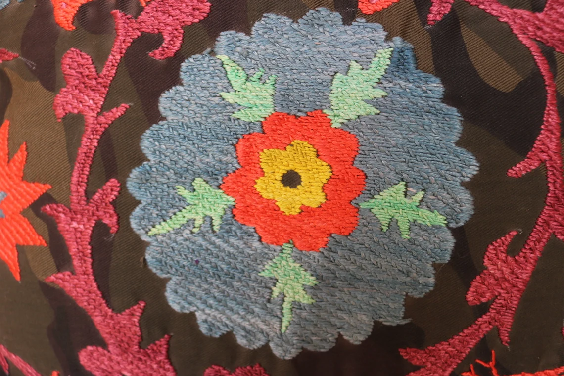 Suzani pillowcase covers are traditional Uzbek textiles, hand-embroidered with vibrant floral and geometric patterns.