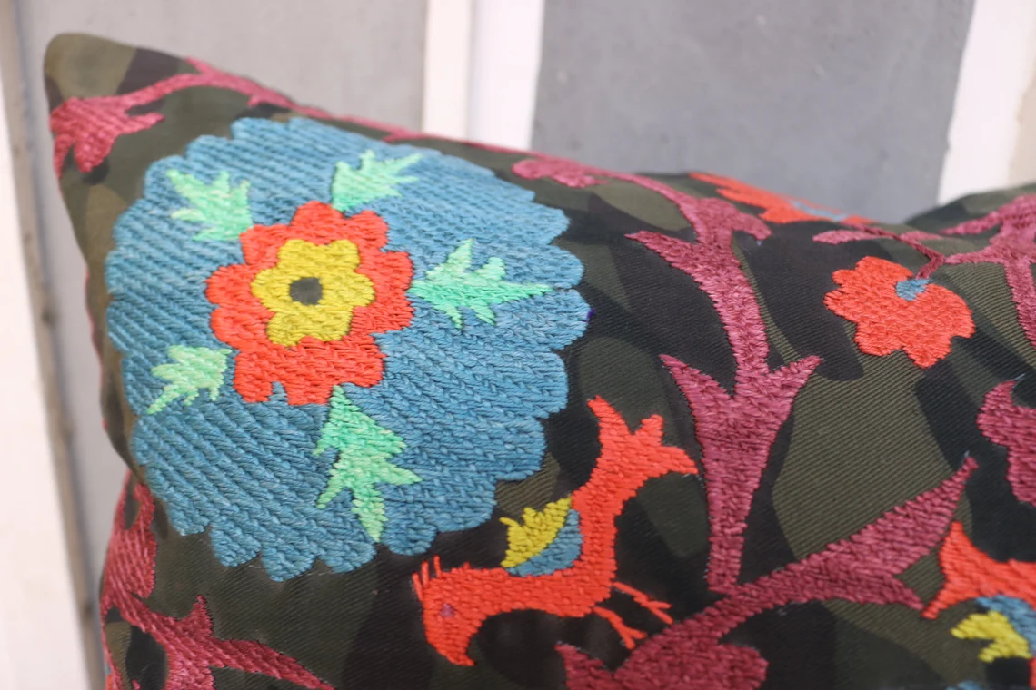 Suzani pillowcase covers are traditional Uzbek textiles, hand-embroidered with vibrant floral and geometric patterns.