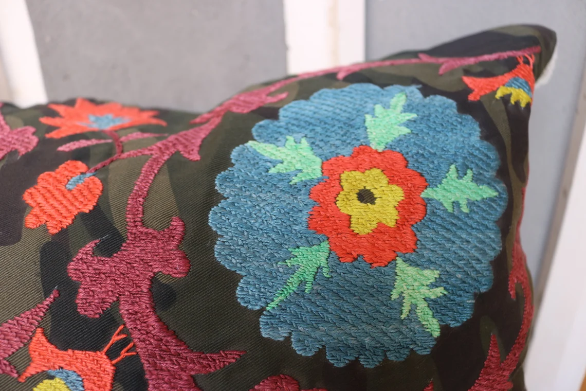 Suzani pillowcase covers are traditional Uzbek textiles, hand-embroidered with vibrant floral and geometric patterns.