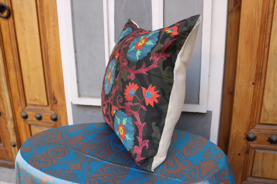 Suzani pillowcase covers are traditional Uzbek textiles, hand-embroidered with vibrant floral and geometric patterns.