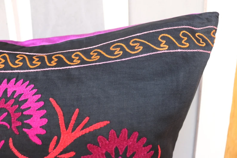 Suzani pillowcase covers are traditional Uzbek textiles, hand-embroidered with vibrant floral and geometric patterns.