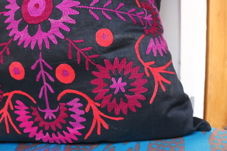 Suzani pillowcase covers are traditional Uzbek textiles, hand-embroidered with vibrant floral and geometric patterns.