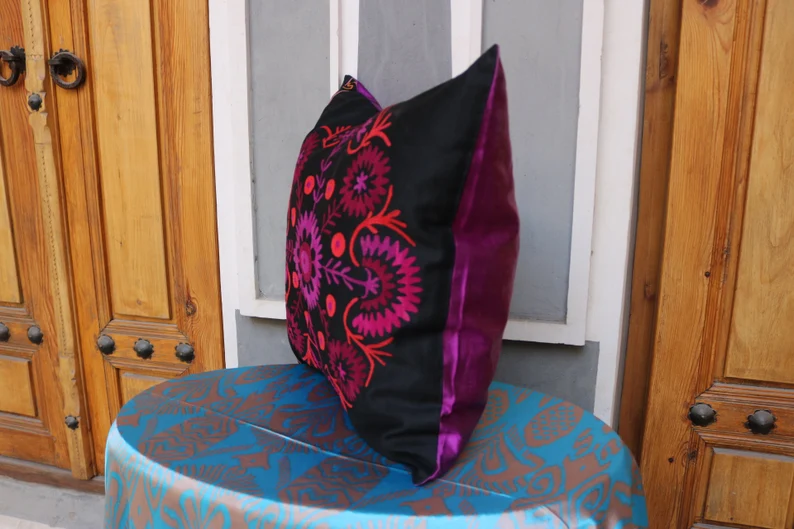 Suzani pillowcase covers are traditional Uzbek textiles, hand-embroidered with vibrant floral and geometric patterns.