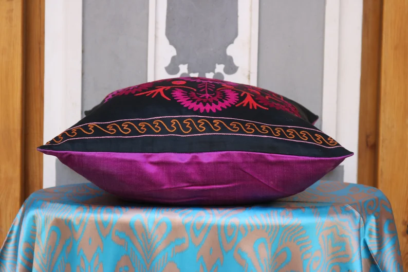 Suzani pillowcase covers are traditional Uzbek textiles, hand-embroidered with vibrant floral and geometric patterns.