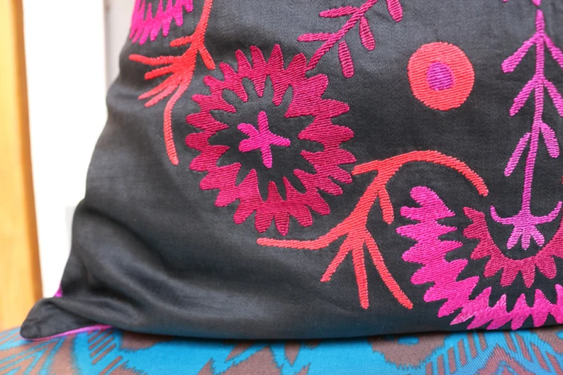 Suzani pillowcase covers are traditional Uzbek textiles, hand-embroidered with vibrant floral and geometric patterns.