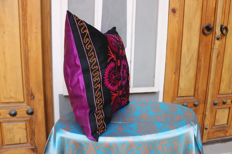 Suzani pillowcase covers are traditional Uzbek textiles, hand-embroidered with vibrant floral and geometric patterns.