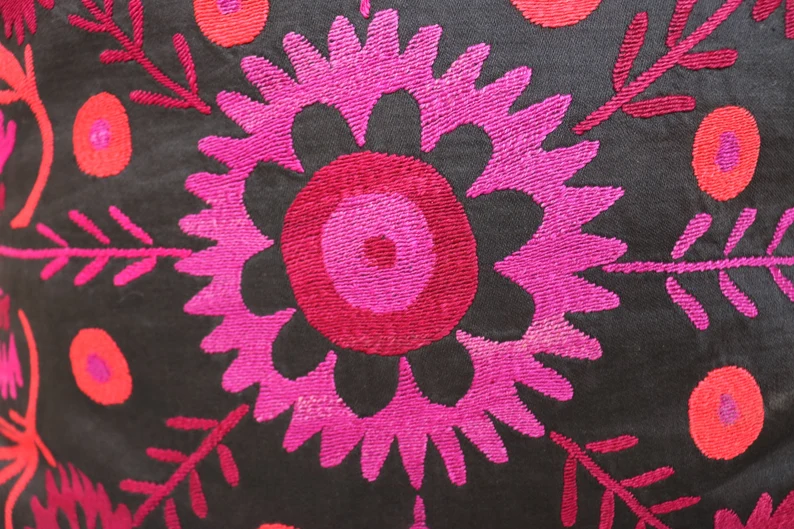 Suzani pillowcase covers are traditional Uzbek textiles, hand-embroidered with vibrant floral and geometric patterns.