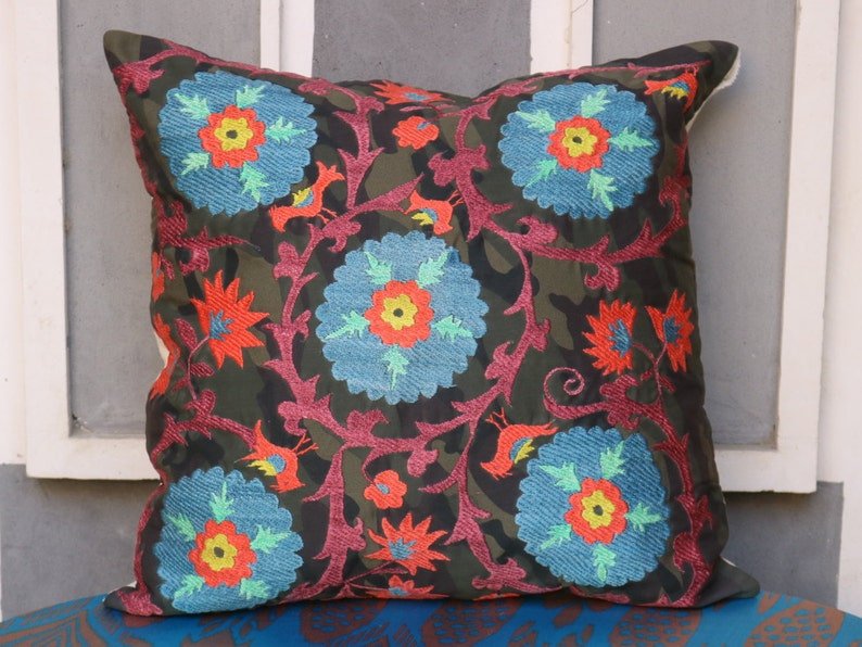 Suzani pillowcase covers are traditional Uzbek textiles, hand-embroidered with vibrant floral and geometric patterns.